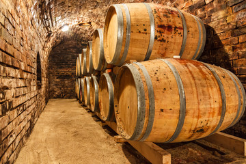 Oak barrels in a underground wine cellar