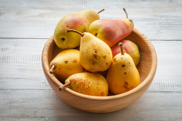 fresh ripe organic pears on a white wooden table