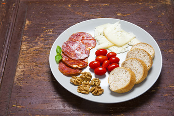 appetizer on a plate. pecorino, parmesan, prosciutto, lavender,