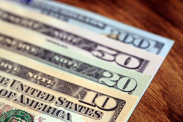 Dollar banknotes on wood surface