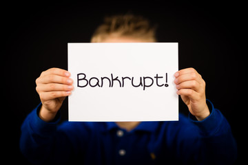 Child holding Bankrupt sign