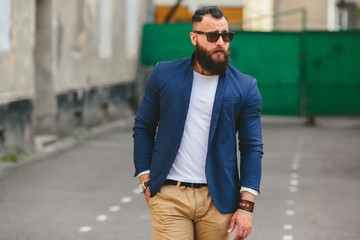 Stylish bearded man walks through the city