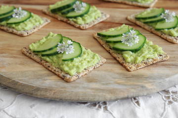 Green cucumber and avocado wholegrain rectangle crackers with co