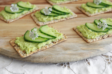 Green cucumber and avocado wholegrain rectangle crackers with co