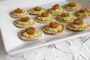 Green avocado and tomato crackers