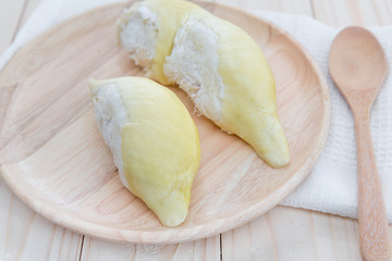 Durian on plate and on wooden background