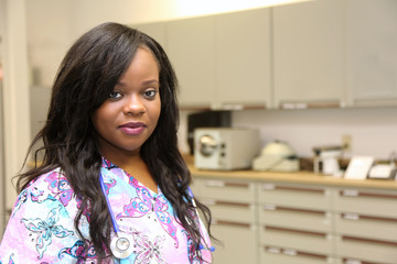 Portrait of young attractive female African American healthcare worker inside medical lab