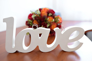 word love inscription costs on a table with rings