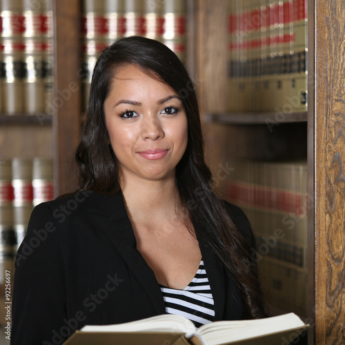 "Portrait of Young Attractive Hispanic Female Lawyer in Law Library