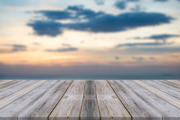 Fototapeta na wymiar Vintage wooden board empty table in front of sunset background. Perspective wood floor over sea and sky - can be used for display or montage your products. beach & summer concepts.