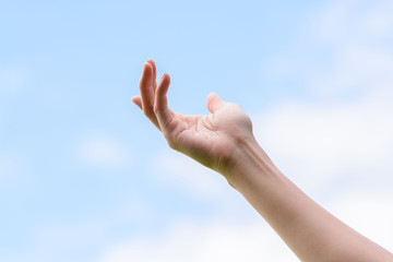 Young woman hand on sky