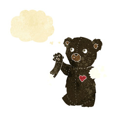cartoon teddy black bear with torn arm with thought bubble