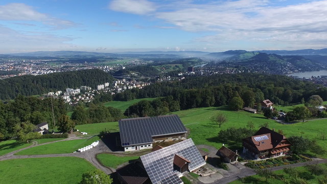 Aerial flight over an farm with solar Panels, Switzerland