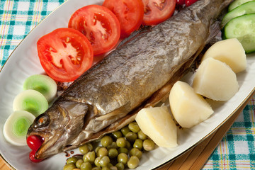 Trout baked in the oven on a country table