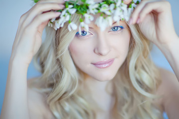 Beautiful woman with snowdrops in her hair 