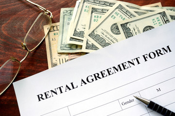 Rental agreement form on a wooden table.