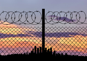 Silhouette of fence and cities away