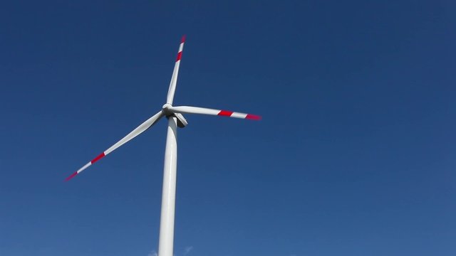 Windmill generator turbine in sky 