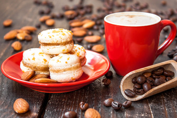 Red cup of coffee and macaroons