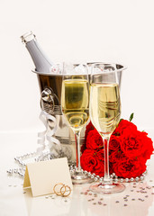 Wedding rings with writing card and champagne