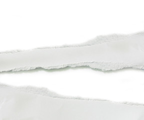 close up of a white ripped piece of paper on white background