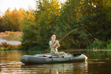 Fisherman on the autumn forest background. Fisherman in his hand