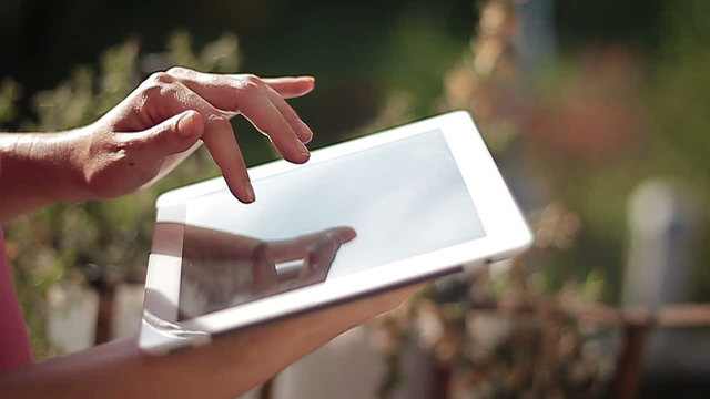 Close up of hands woman using her tablet