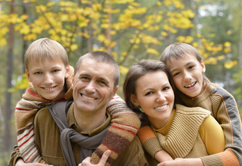 Happy smiling family relaxing in autumn 