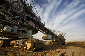 One side of huge mining drill machine photographed from a ground with wide angle lens. Dramatic and...