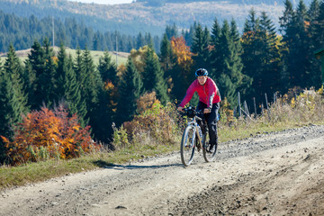 Mountain biker in autumn forest