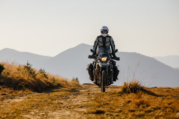 Motorbiker travelling in autumn mountains - 92278602