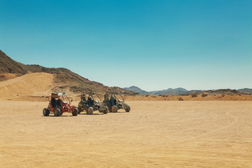 three atv standing in hot desert © Dmitry Sosenushkin