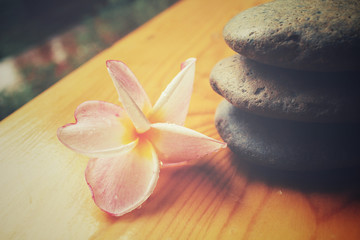 Frangipani flower with spa stones