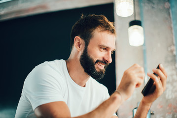 Mock up of bearded man sending text message