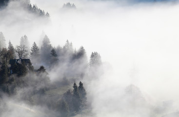 Bavarian mountain village in dense fog