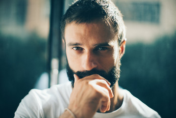 Close up of a bearded man wearing white tshirt