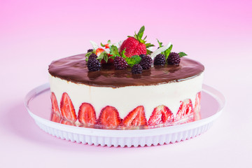 Strawberry fraisier cake on pink gradient background