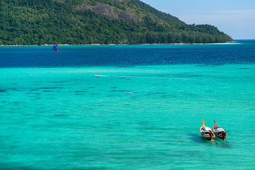 Andaman sea  two deep color sea with long tail boat and island
