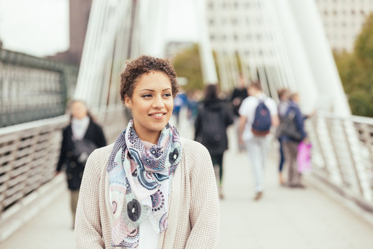 Young Mixed Race Woman Walking On A Bridge In London