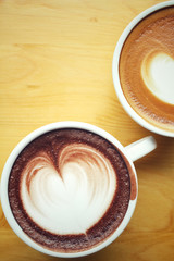 Vintage latte art coffee with hot chocolate
