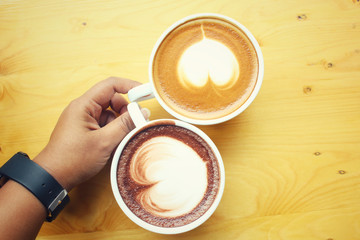 Vintage latte art coffee with hot chocolate