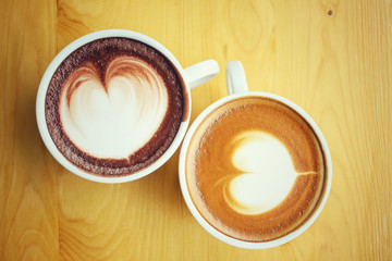 Vintage latte art coffee with hot chocolate