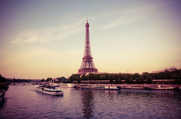Fototapeta na wymiar Eiffel Tower with boats in evening Paris, France