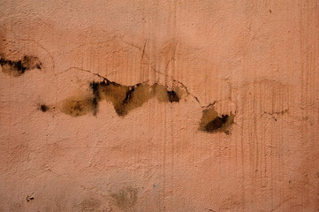Fototapeta na wymiar Texture of old wall covered with brown stucco