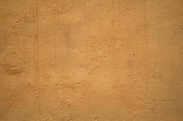 Texture of old wall covered with yellow stucco