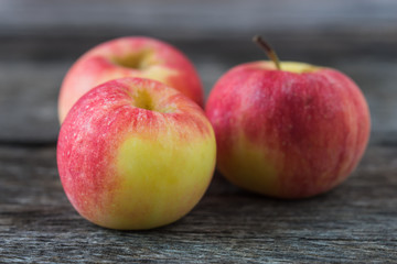 Apples on old wooden background.