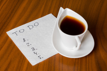 coffee cup with handwriting todo list on napkin 2