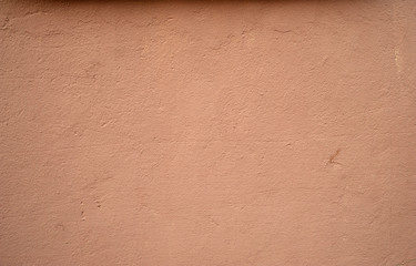 Texture of old wall covered with pink stucco