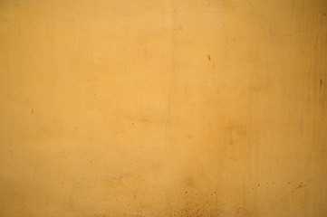 Texture of old wall covered with yellow stucco