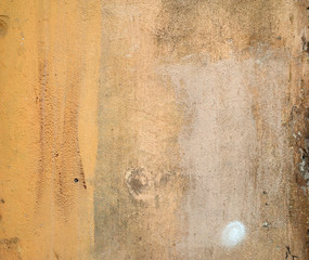 Texture of old wall covered with yellow stucco